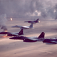 Two F-15E Strike Eagles fly with a pair of F-16A Fighting Falcons and a lighter-colored F-15C Eagle over burning Kuwaiti oil fields during Operation Desert Storm in 1991 (US Air Force)